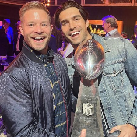 Peter Porte and his partner, Jacob Jules Villere, took a picture with an NFL trophy.